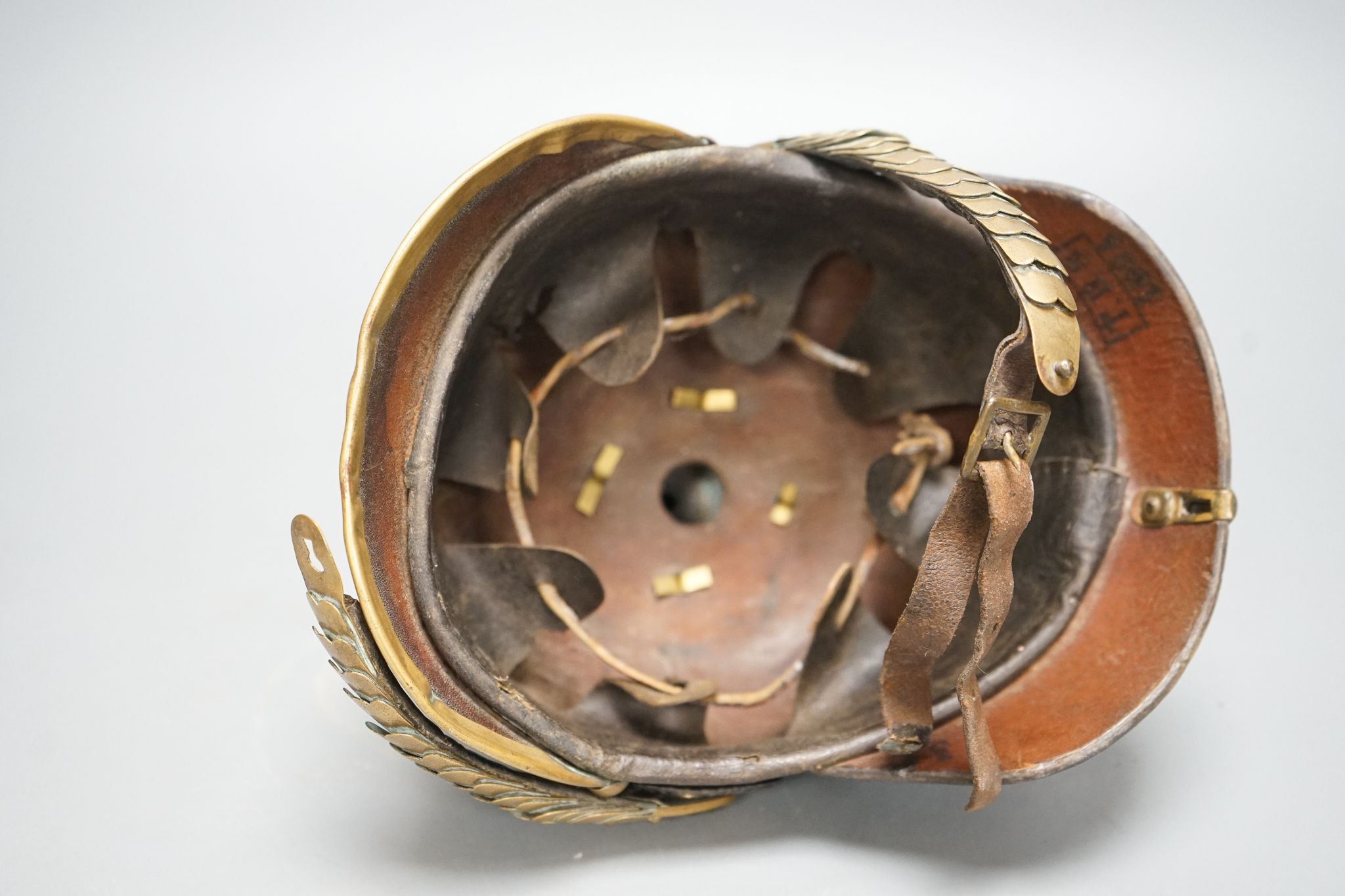 A WW1 Prussian pickelhaube, the leather skull with brass spiked top and eagle plate